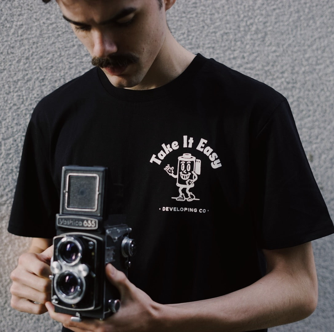 Model wearing Don't be negative t-shirt - Take it Easy Lab