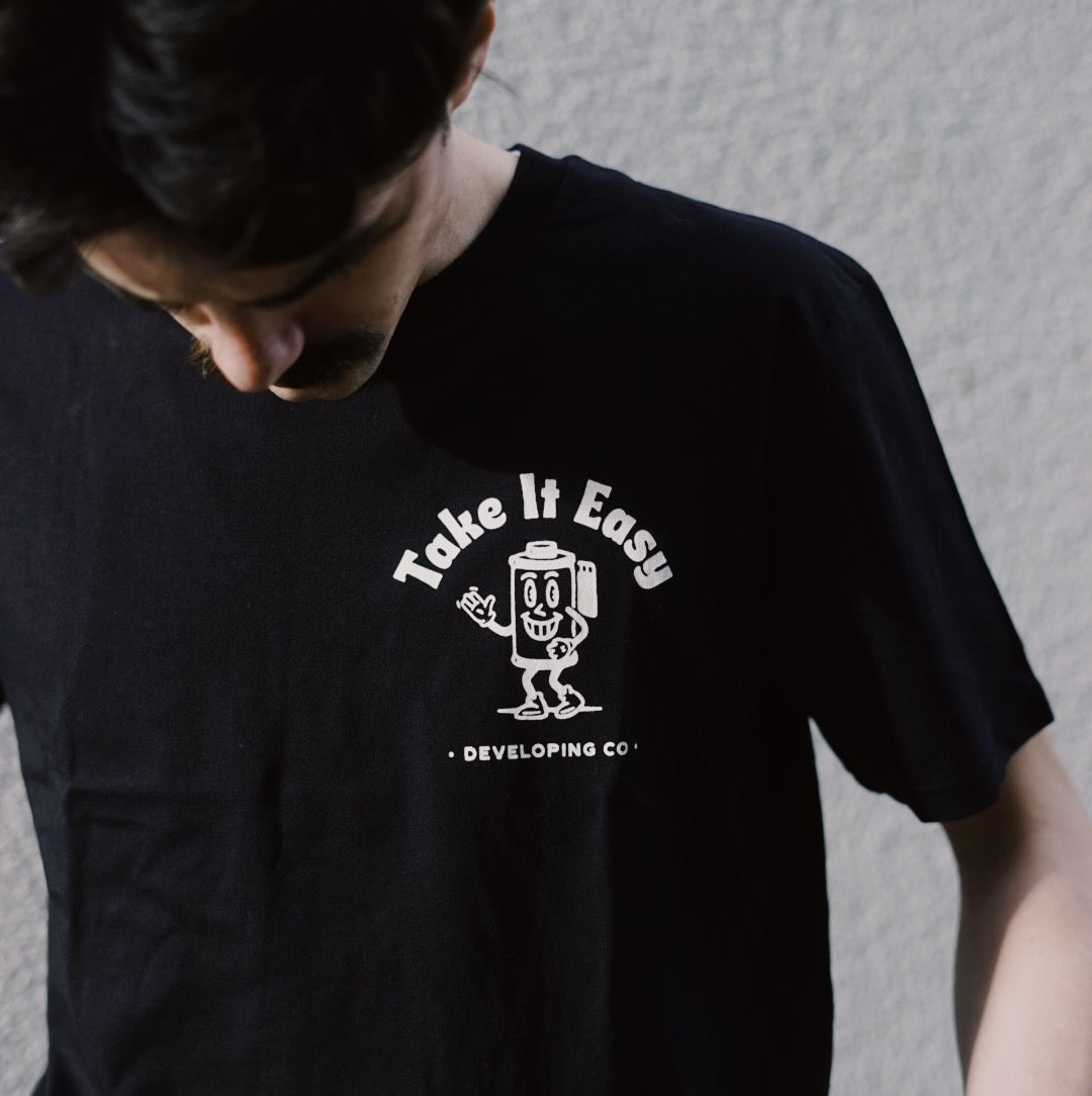 Model wearing Don't be negative t-shirt - Take it Easy Lab