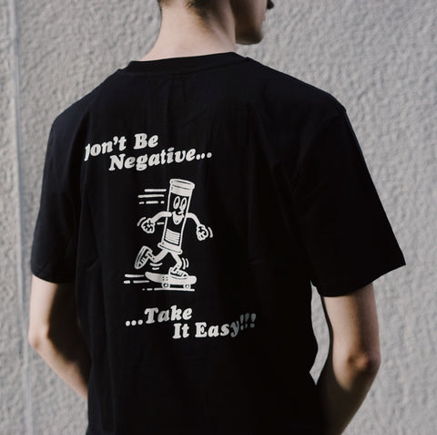 Model wearing Don't be negative t-shirt - Take it Easy Lab